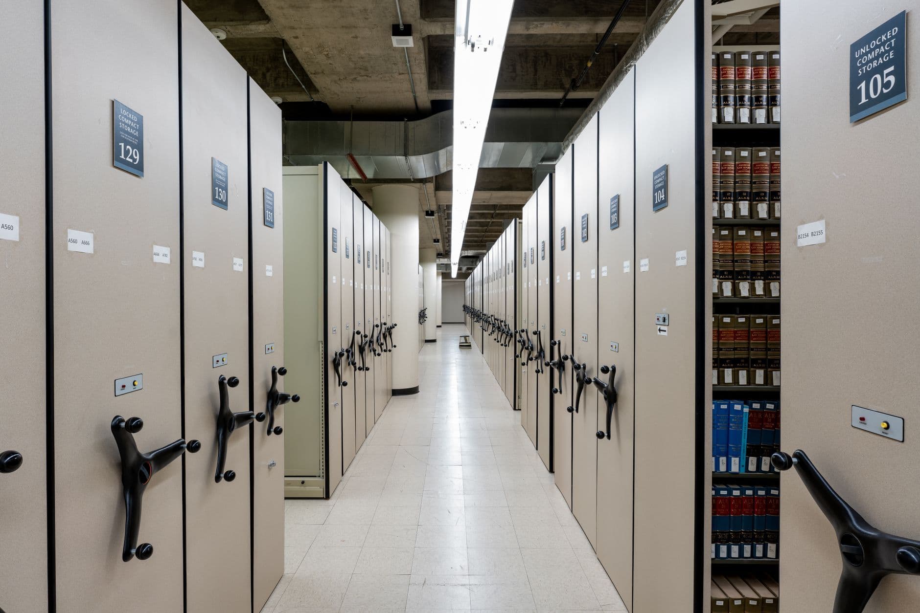 Spacious library archive with organized compact shelving and storage units.